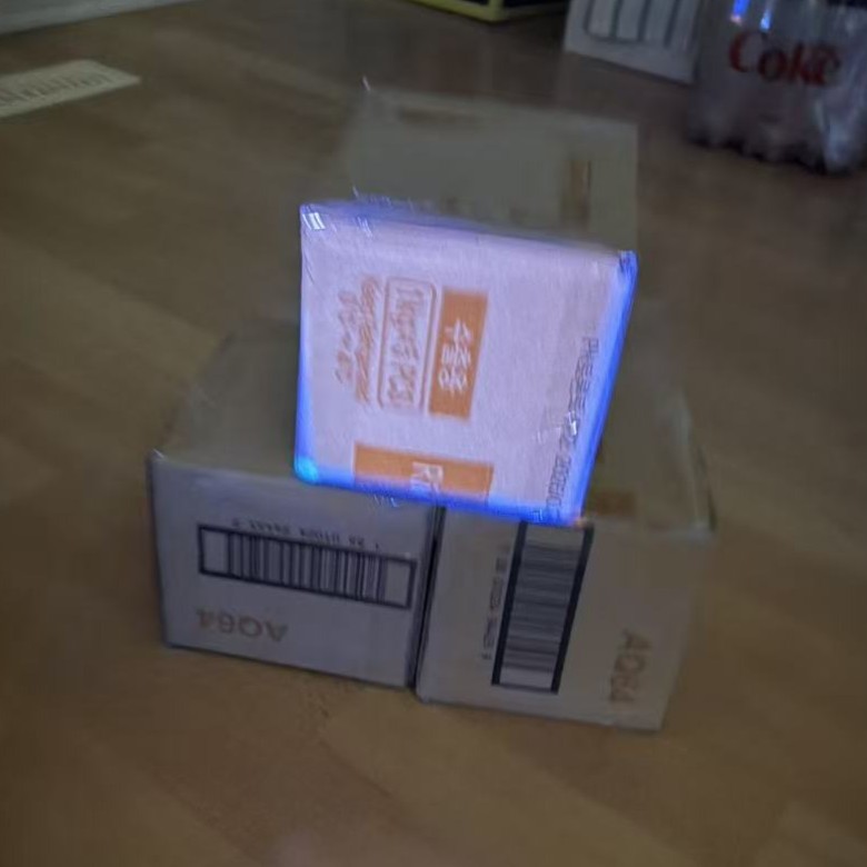 Using TouchDesigner to project images onto cardboard boxes.